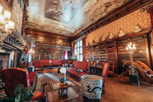 Luxurious study room with a large-capacity bookshelf showcasing a mix of books, art pieces, and elegant lighting.