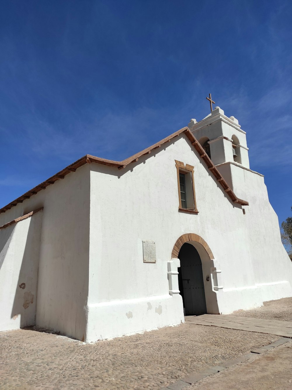 a white church with a cross on top of it