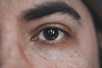 a close up of a man's brown eye