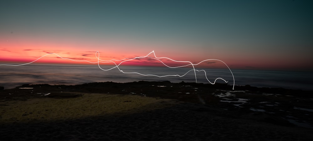 a long exposure photo of a sunset over the ocean