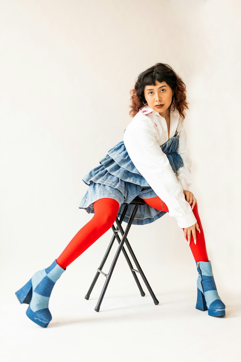 a woman sitting on a chair with her legs crossed