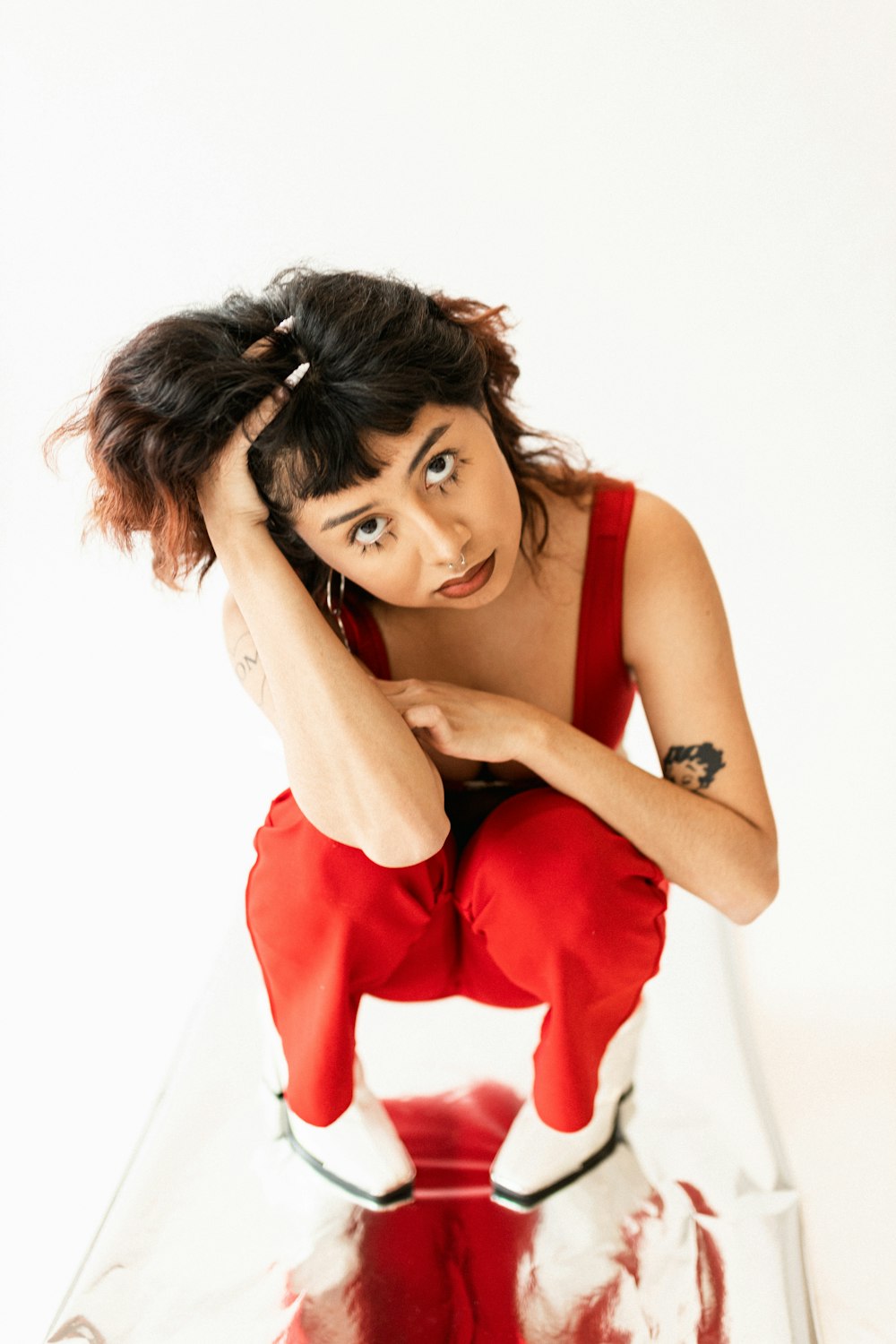 a woman sitting on top of a red object