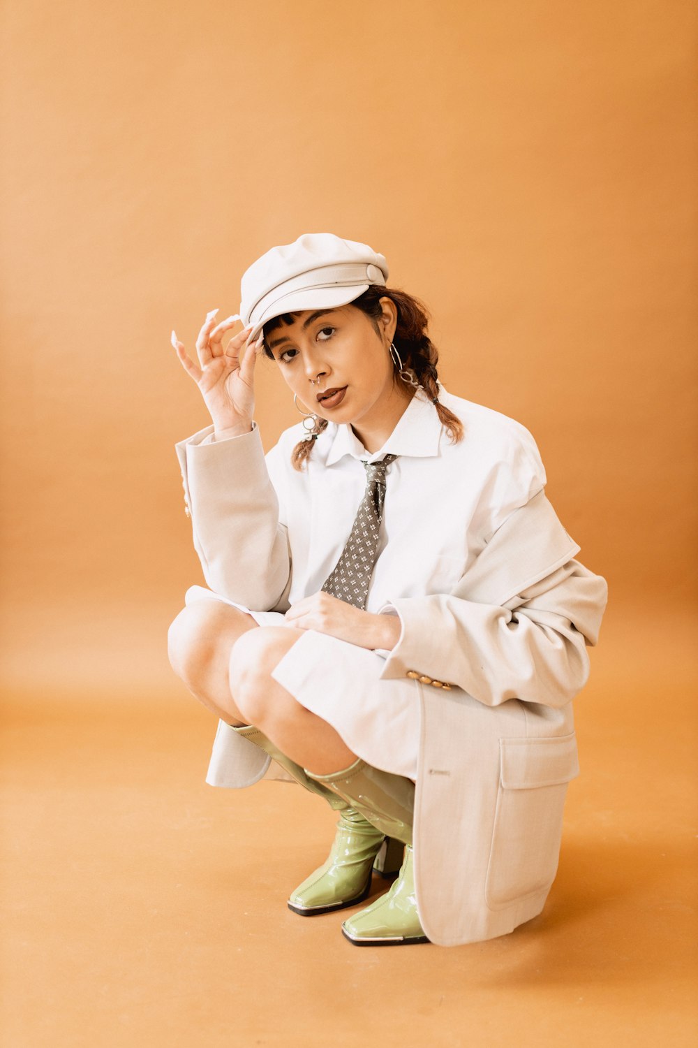 a woman in a white shirt and tie sitting on a chair