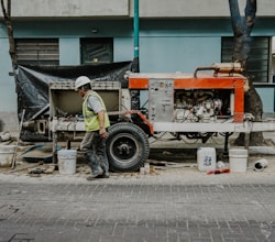 a man in a hard hat is working on a truck