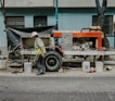 a man in a hard hat is working on a truck