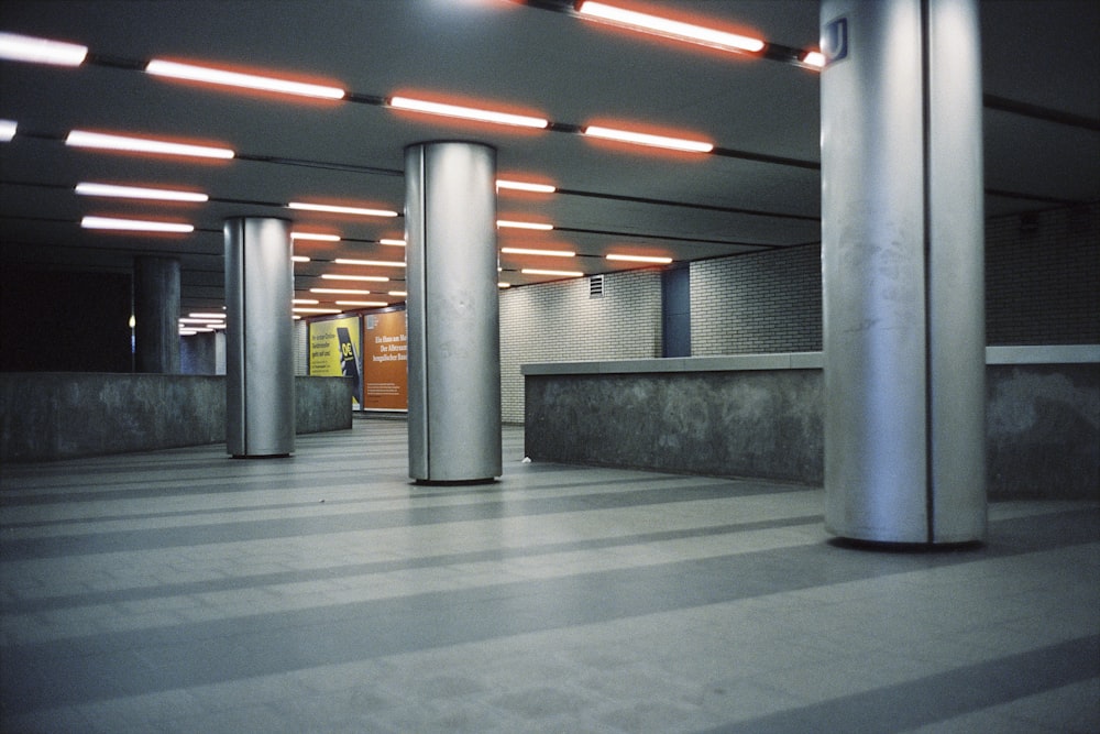 an empty parking garage with columns and lights