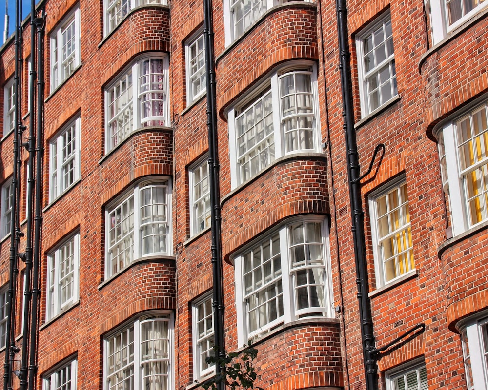 a red brick building with many windows and a clock