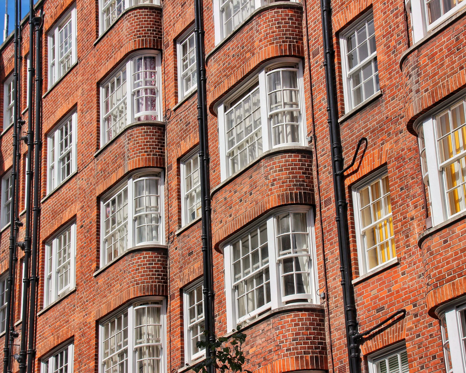 A red brick mansion block with rows of sash windows