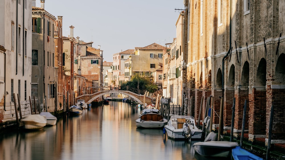 a canal with several boats in it next to buildings