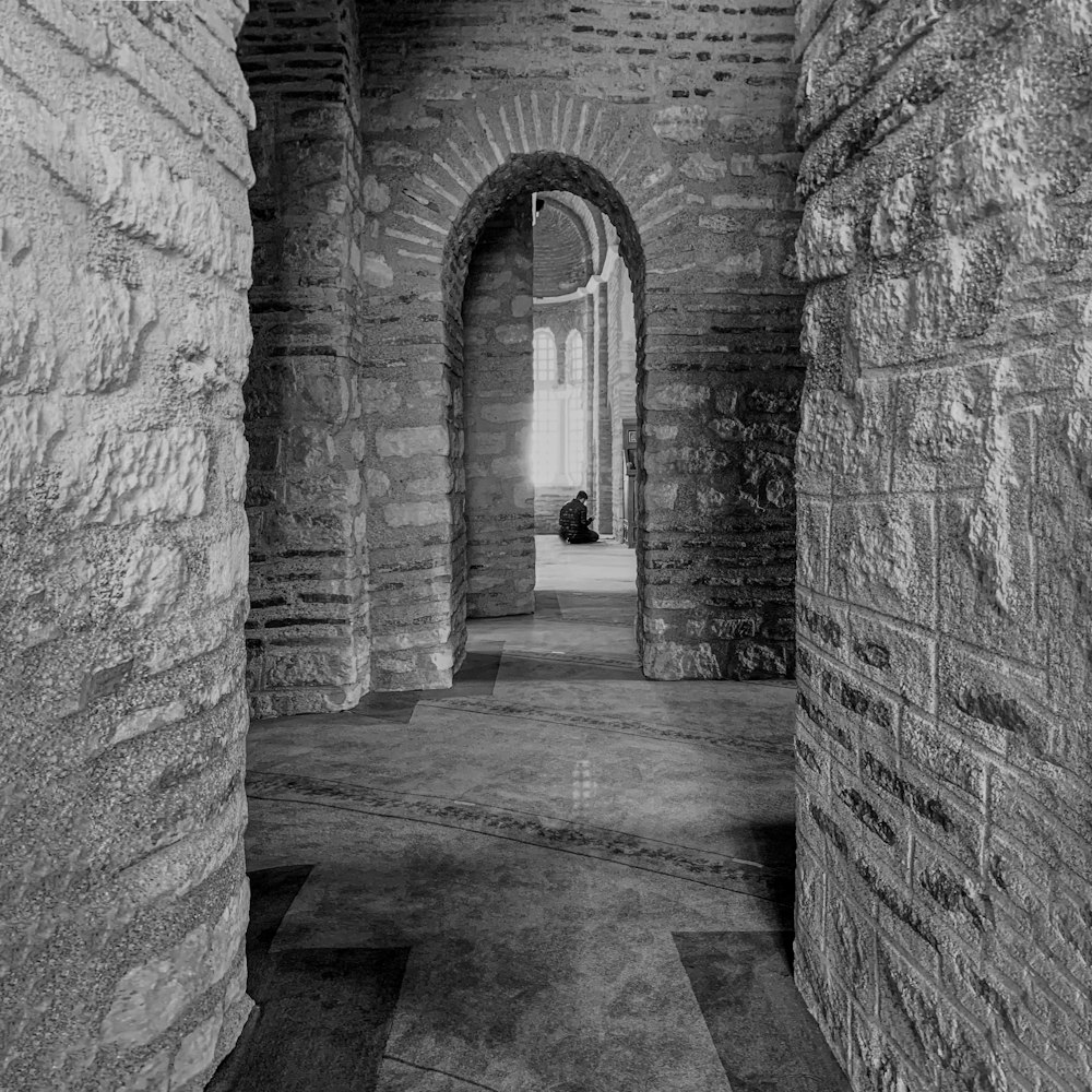 a black and white photo of a narrow hallway