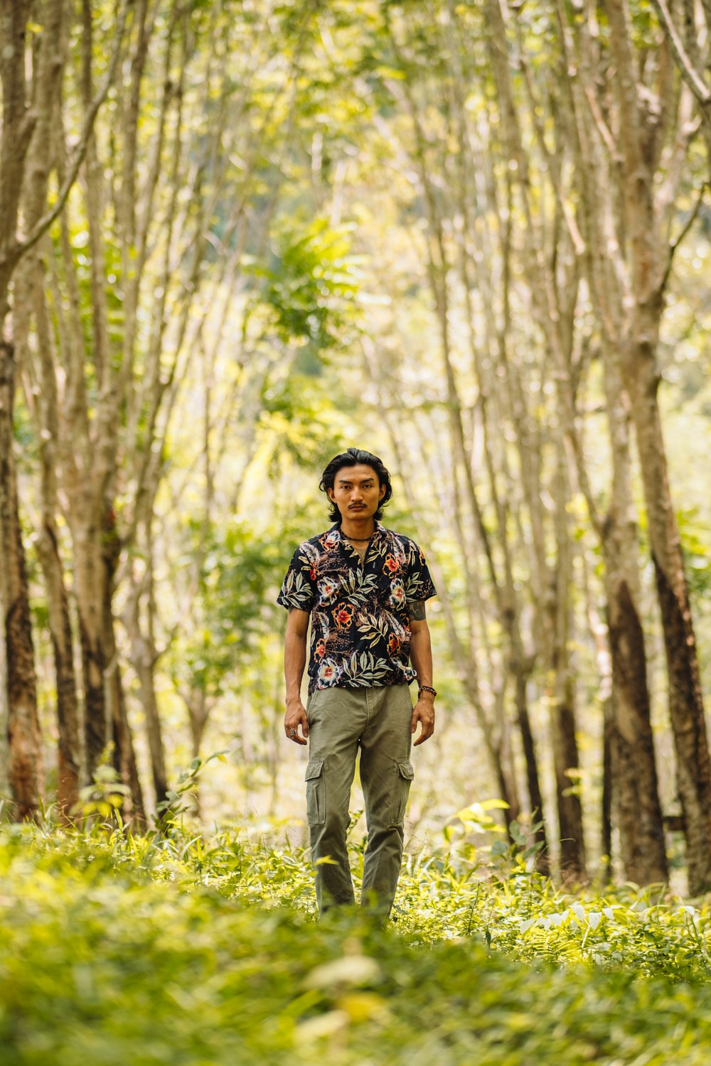 a man standing in the middle of a forest