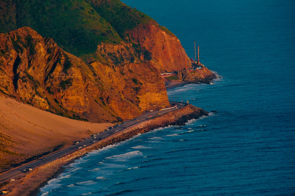 a long stretch of beach next to a cliff