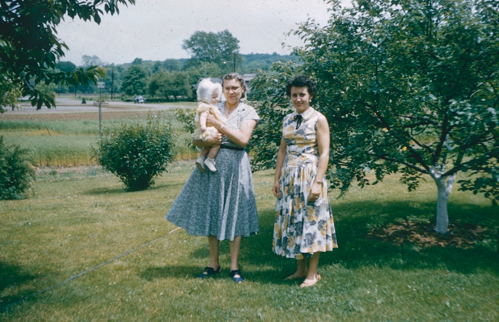 a couple of women standing next to each other on a field