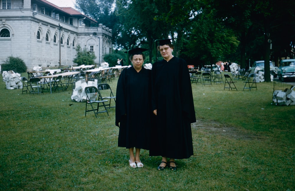 a couple of people that are standing in the grass