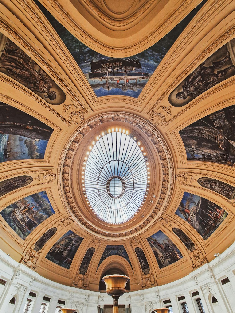 the ceiling of a building with a dome and paintings on it