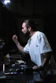 A close-up of Henry inspecting product samples with a focused expression.