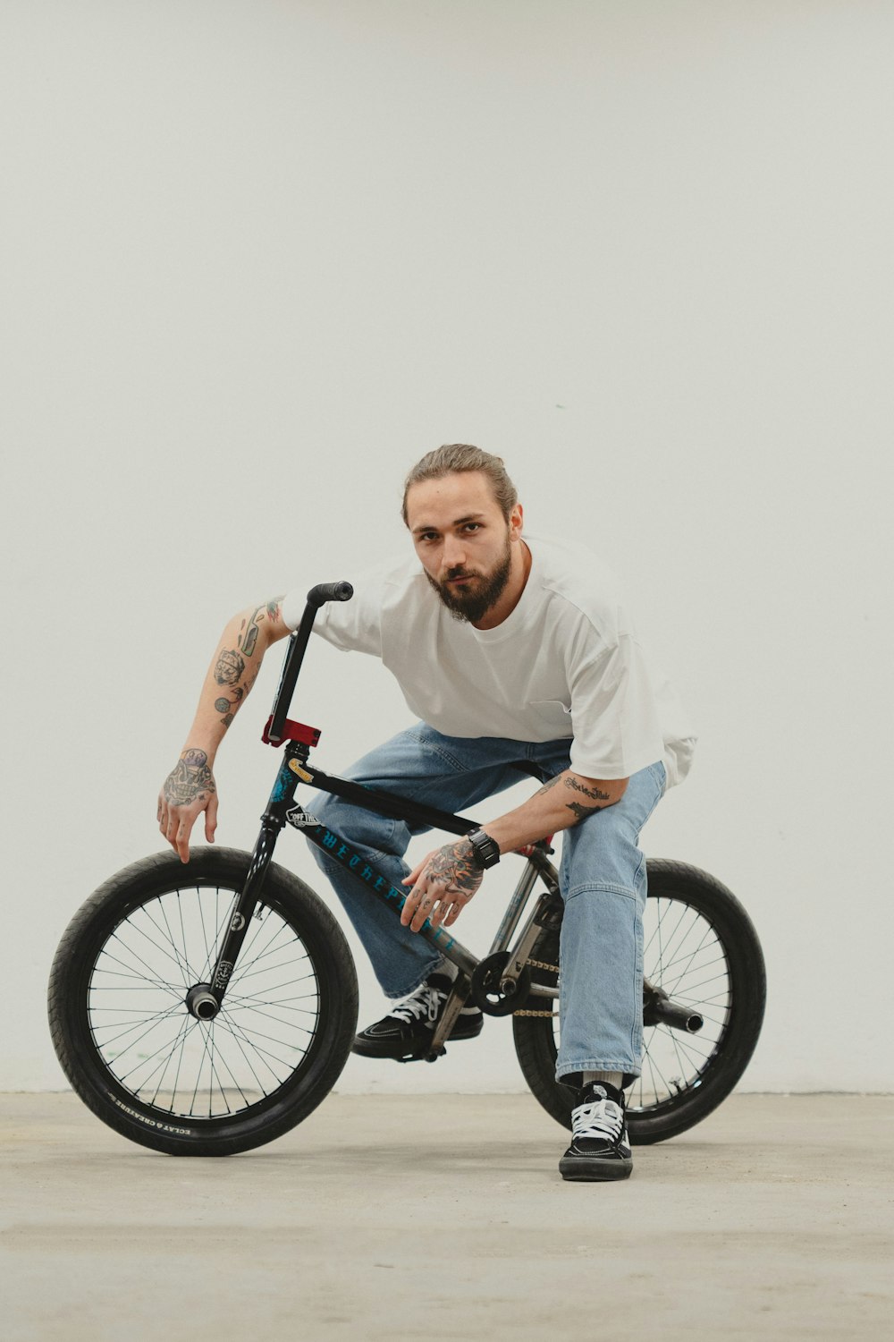 a man sitting on top of a black bike