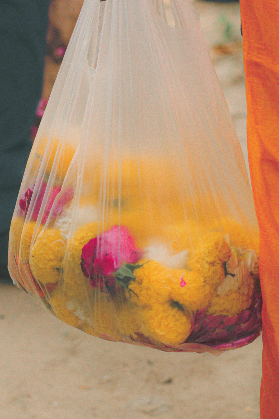 Marigold and rose offerings in a bag at a temple