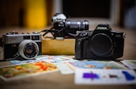A still life composition featuring vintage cameras and photography tools.