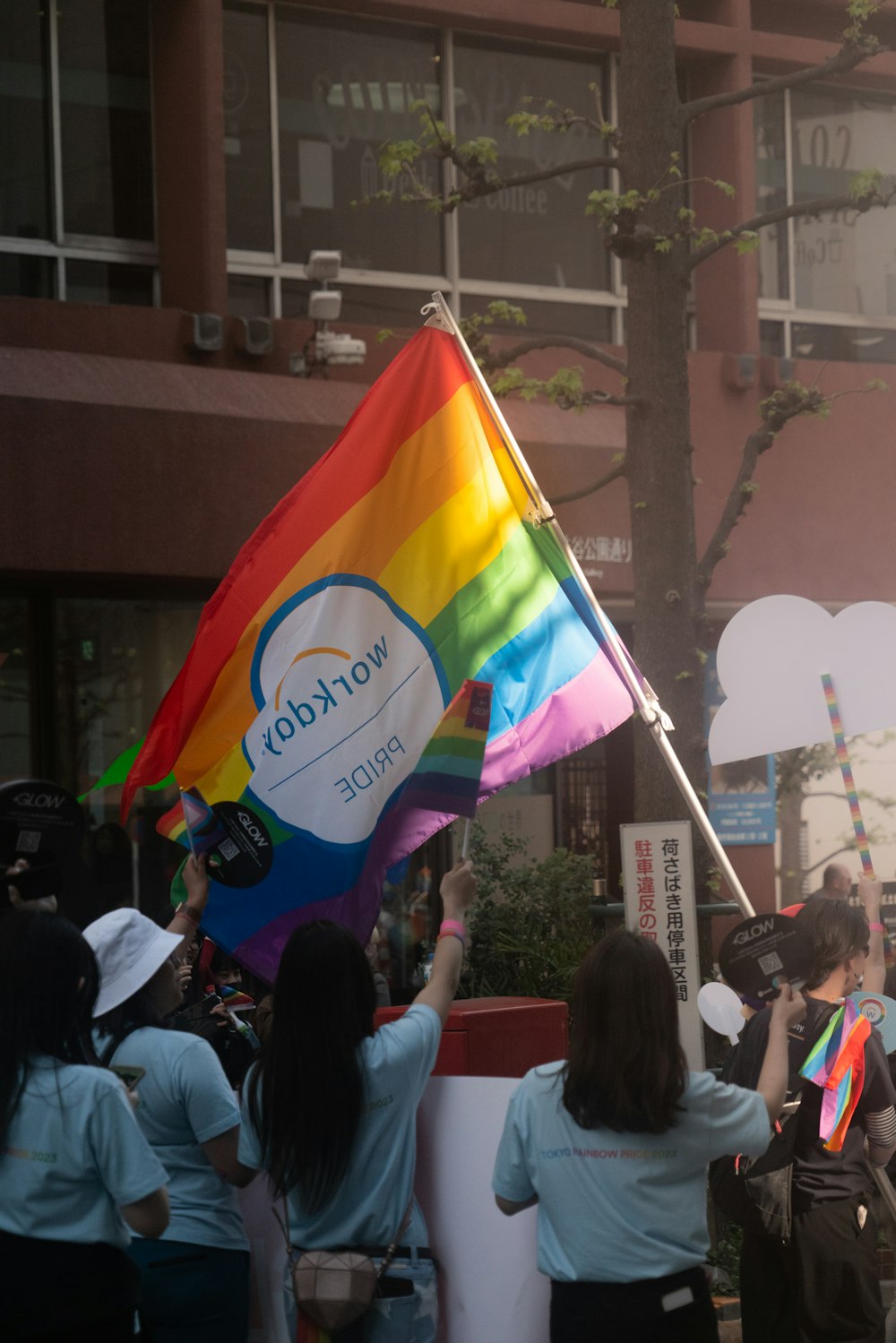 a group of people holding a rainbow flag