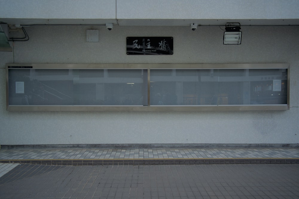 a white building with two windows on the side of it