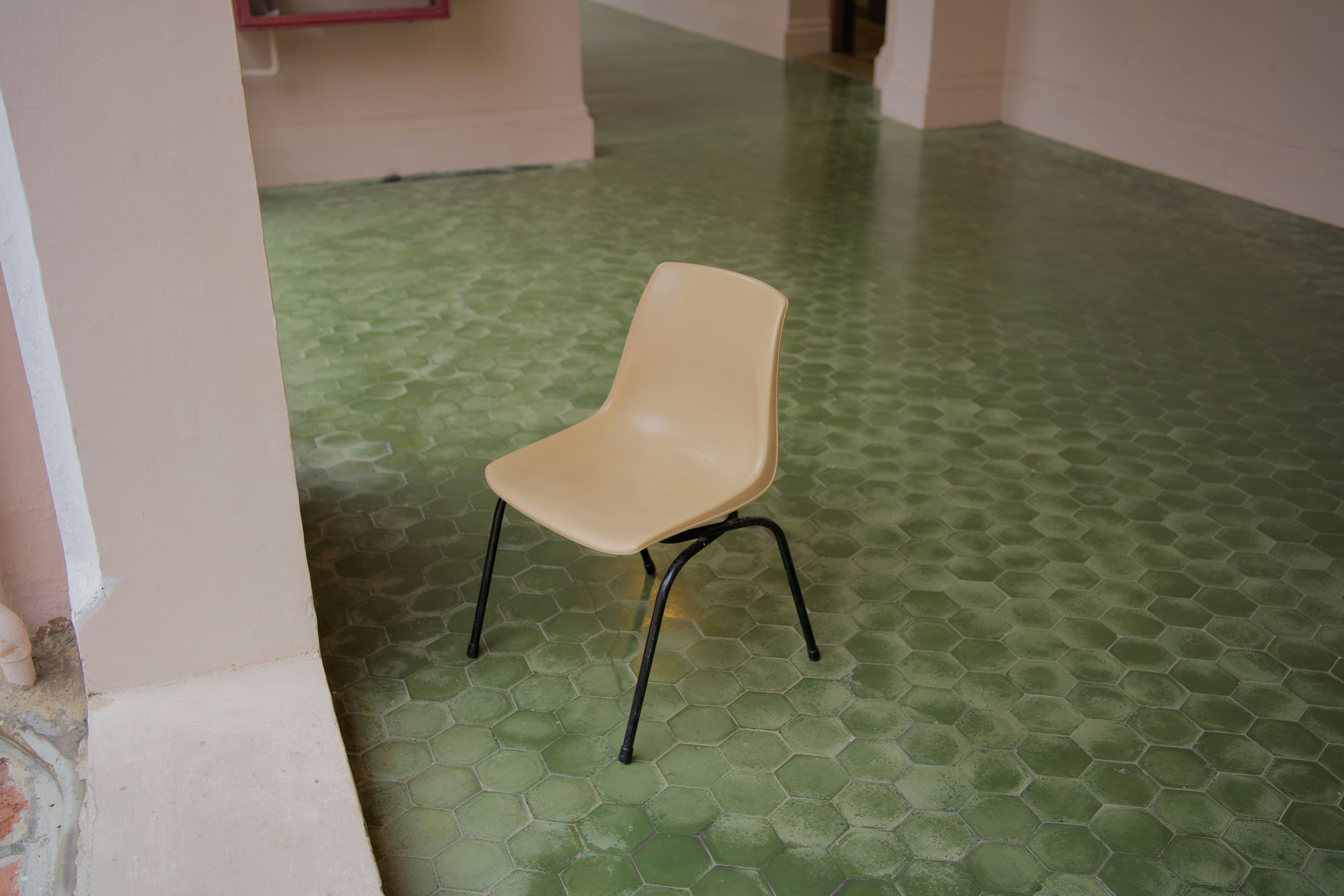 a white chair sitting on top of a green floor