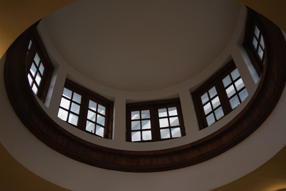 a circular room with three windows and a skylight