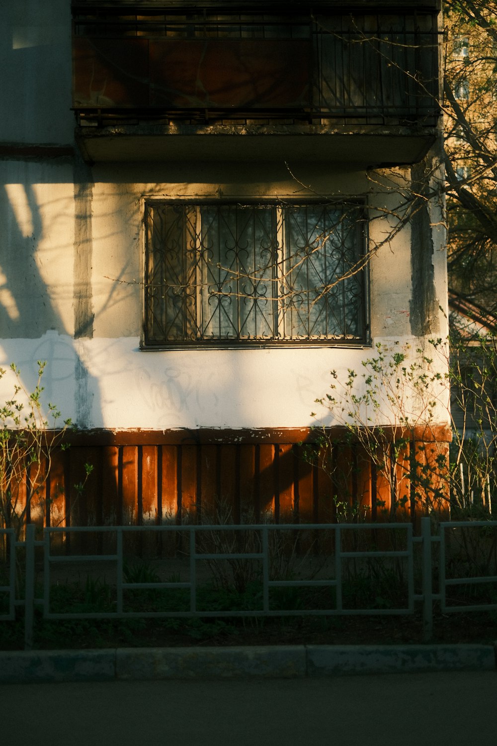 a white building with a wooden fence in front of it