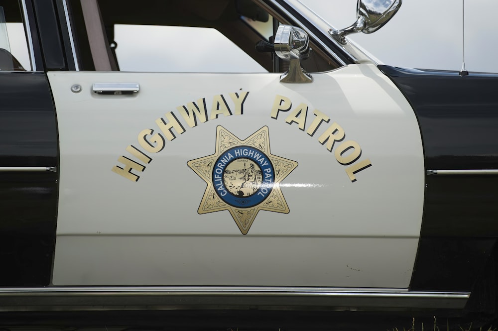 a highway patrol car parked on the side of the road