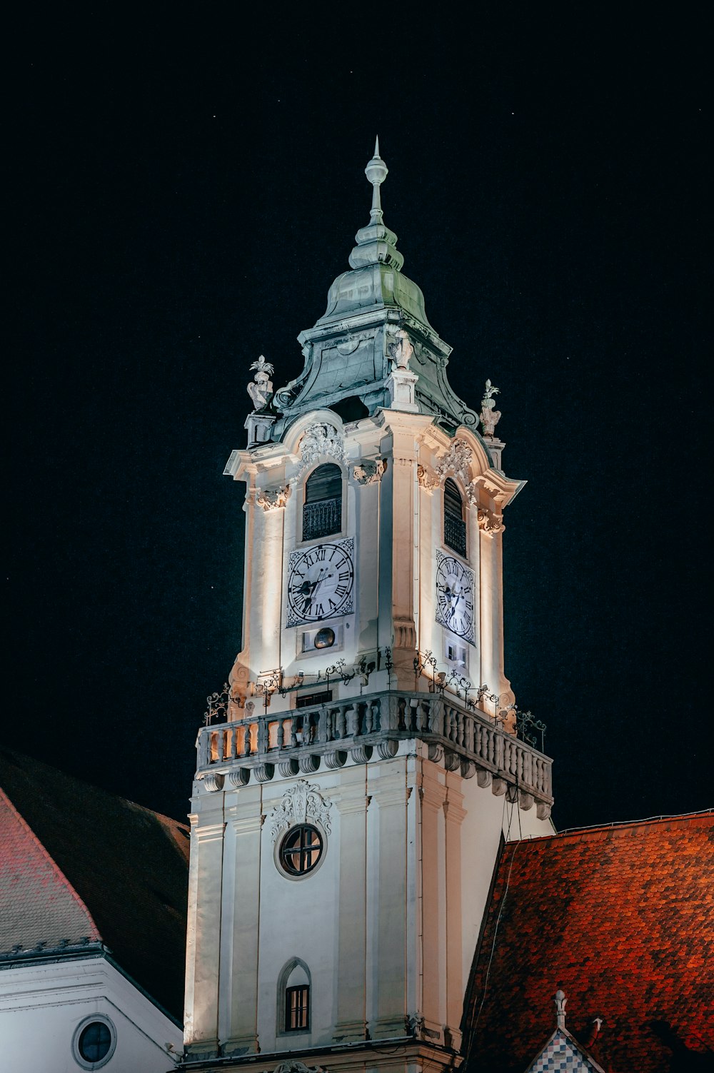 a tall clock tower with a clock on each of it's sides