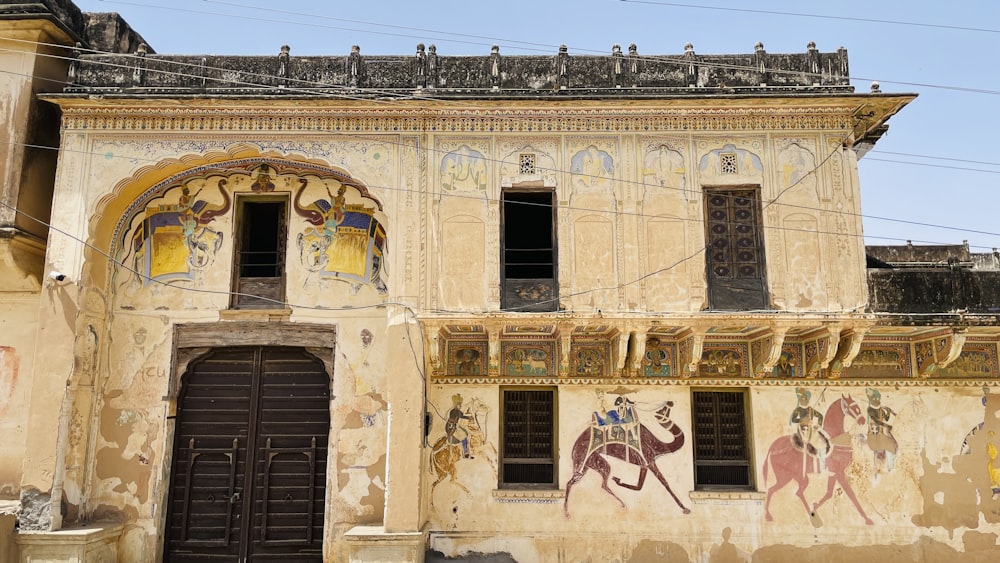 an old building with paintings on the side of it