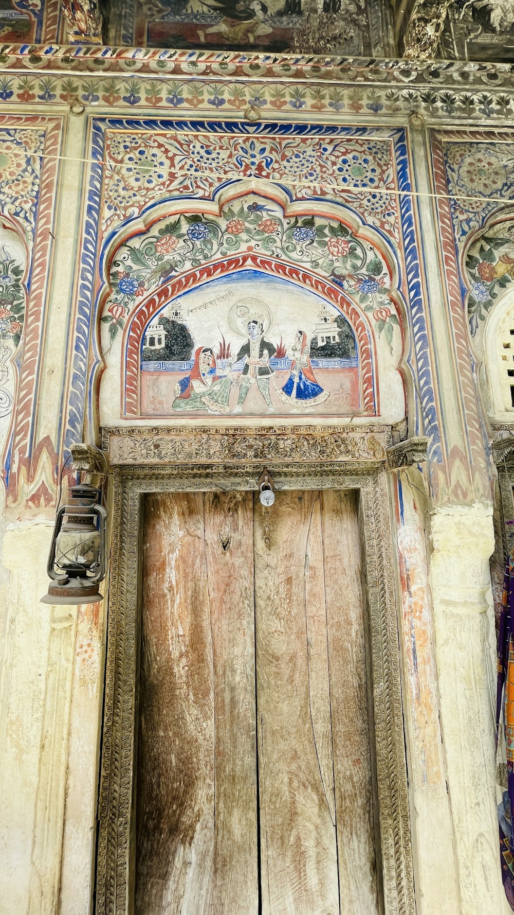 a wooden door with a painting on it