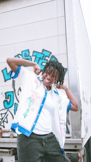 Model wearing Lost Tribe apparel standing next to a customized vehicle.