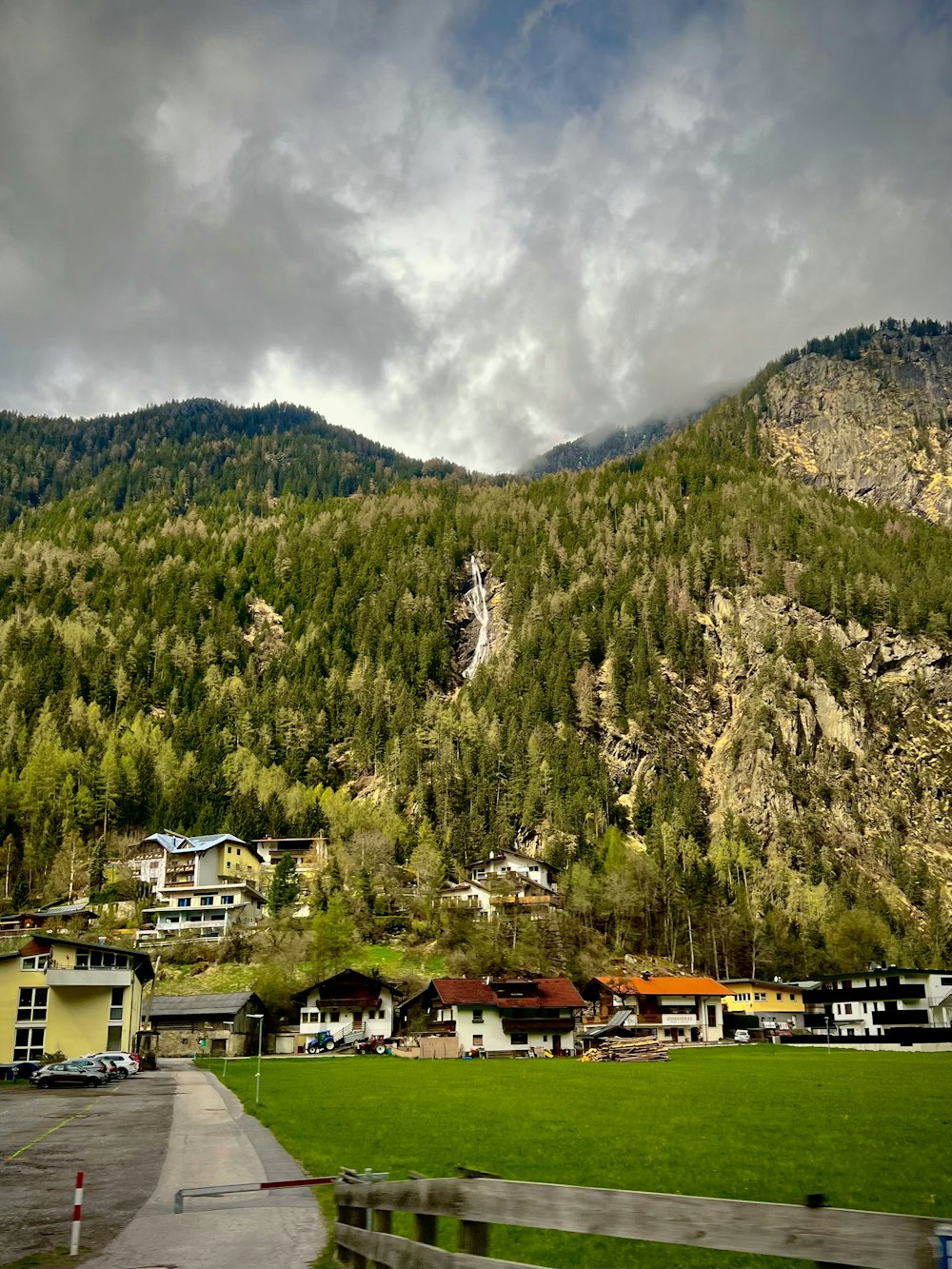 a scenic view of a mountain with houses and trees