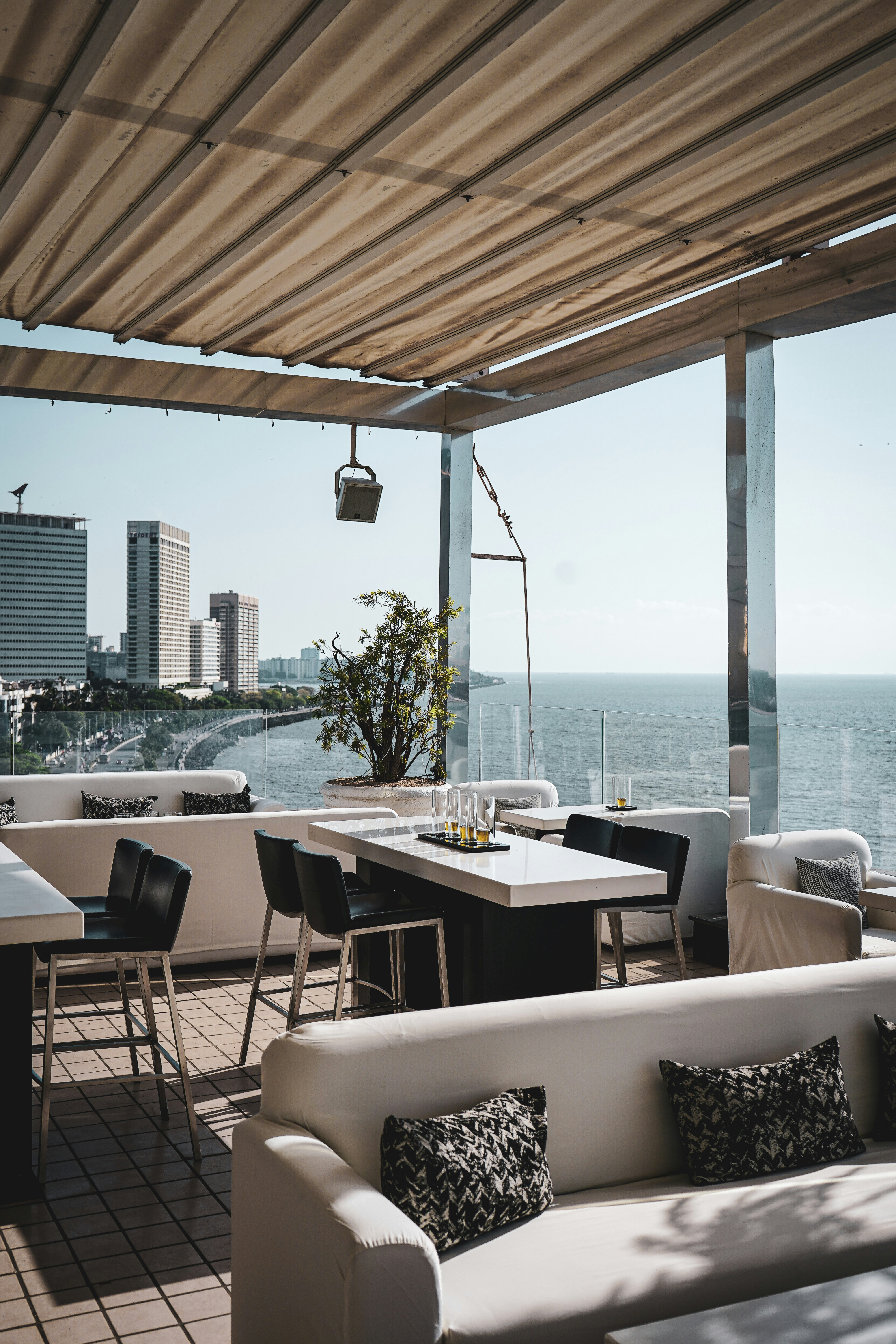 a living room filled with furniture next to the ocean