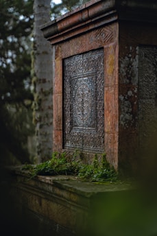 A weathered rune stone standing tall amidst a misty Nordic forest at dawn.