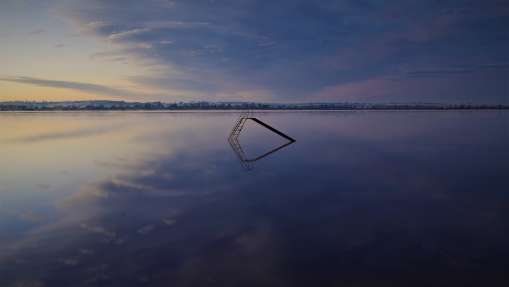 a large body of water with a sky in the background