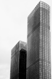 a black and white photo of two skyscrapers