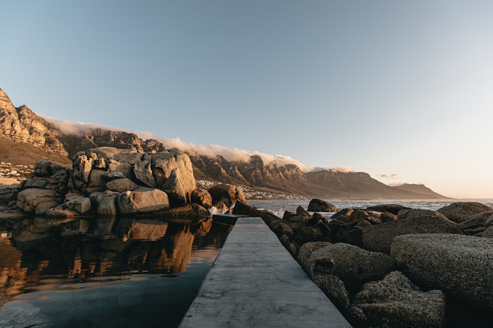 a long dock sitting next to a body of water