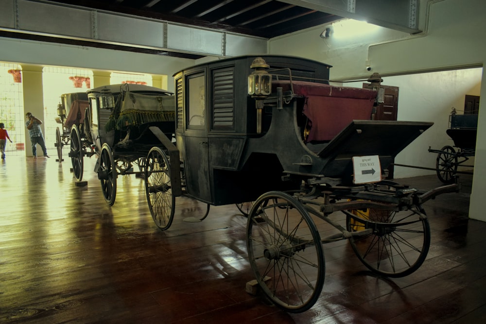 a horse drawn carriage sitting inside of a building