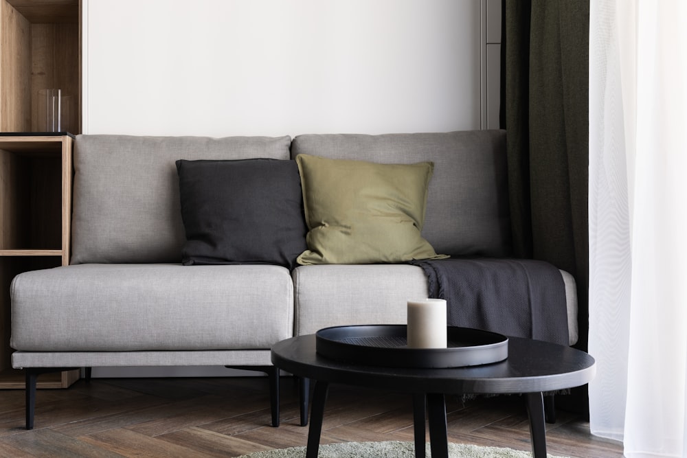 a living room with a couch, coffee table and bookshelf