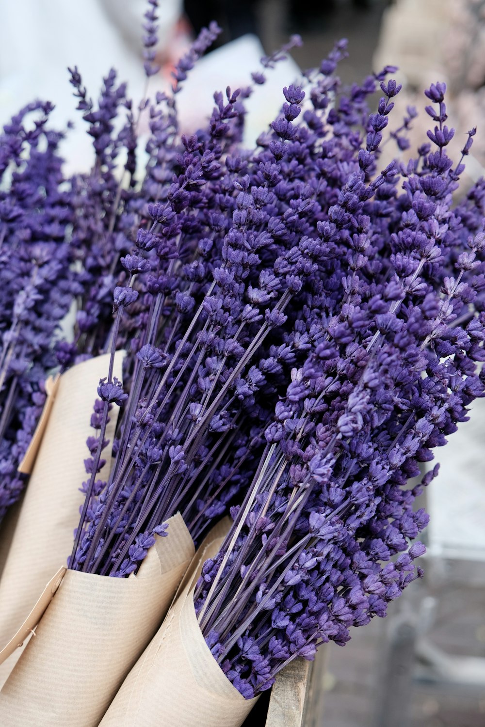 a bunch of purple flowers sitting in a basket