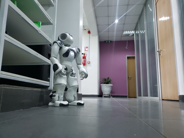 A sleek autonomous robot navigating a modern office lobby, assisting with cleaning and guest services.