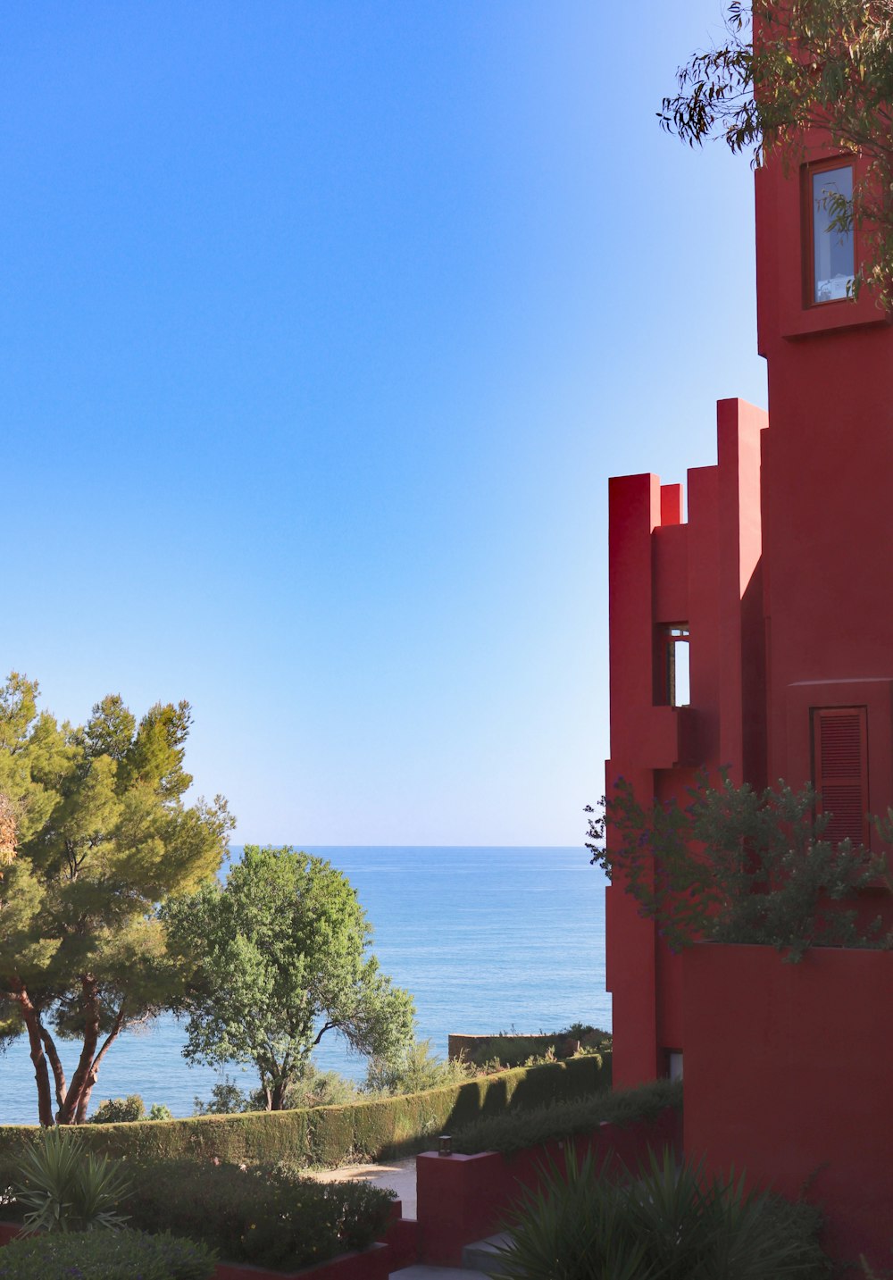 a view of the ocean from a red building