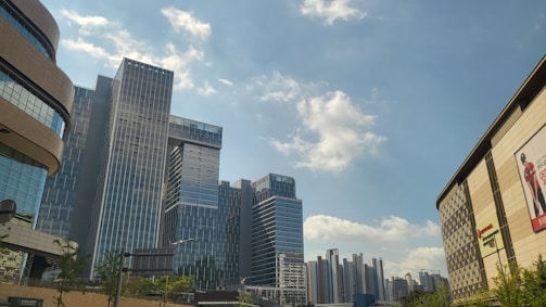 A cityscape with eco-friendly billboards and greenery.