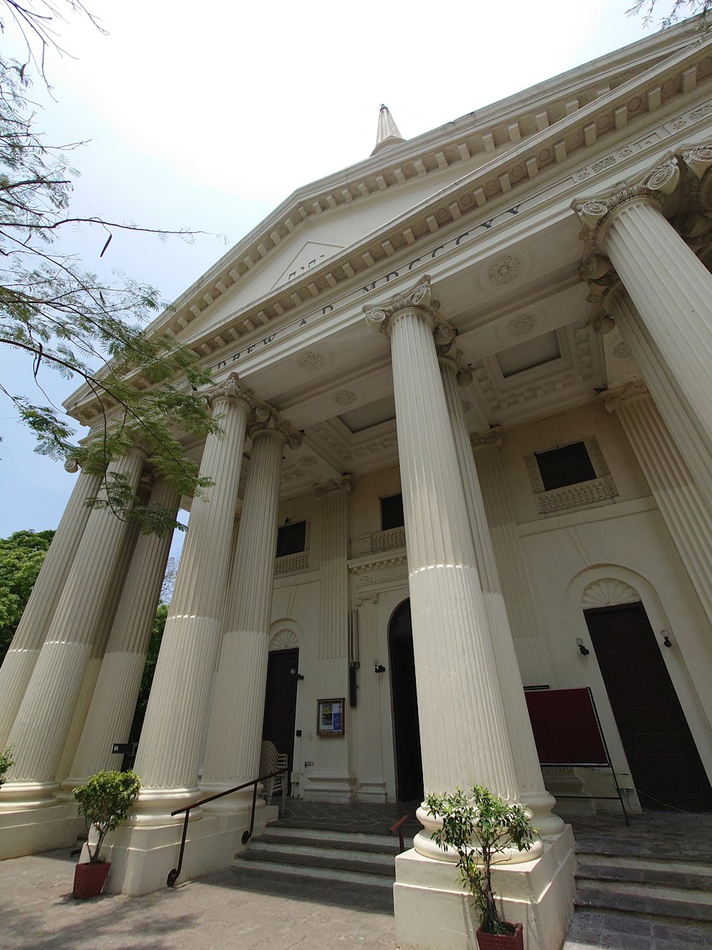 a large white building with columns and a clock tower