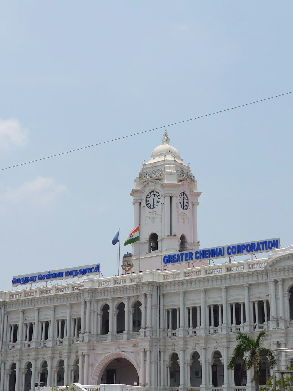 a large white building with a clock tower