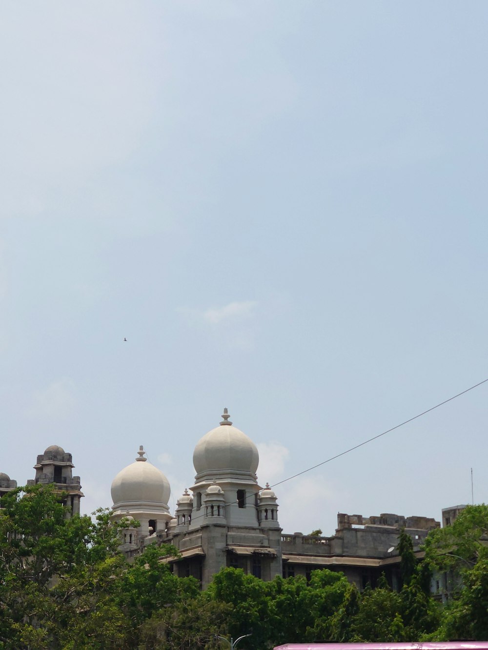 a large white building with two domes on top of it