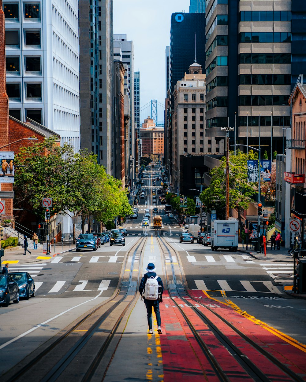 a man walking down a street with a backpack on