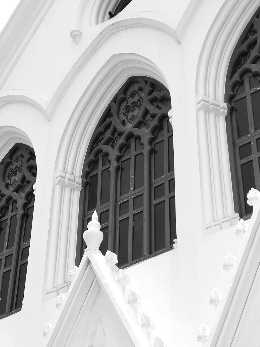 a black and white photo of a church with arched windows